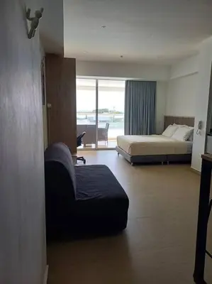 a hotel room with two beds and a couch at New Apartment very close to Airport and beaches in Cartagena de Indias