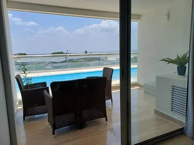 a dining room with a view of the ocean from a house at New Apartment very close to Airport and beaches in Cartagena de Indias