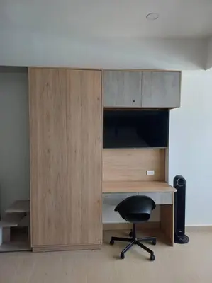 a desk with a chair next to a wooden cabinet at New Apartment very close to Airport and beaches in Cartagena de Indias