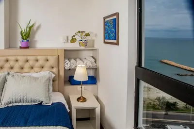 a bedroom with a bed with a view of the ocean at Muranocentro1601 in Cartagena de Indias