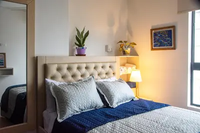a bedroom with a bed with a blue comforter at Muranocentro1601 in Cartagena de Indias