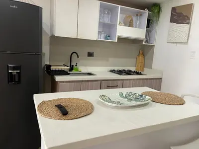 a kitchen with a counter with two hats on it at Hermoso Apartamento cerca a la playa in Cartagena de Indias