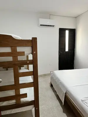 a bedroom with a wooden bed and a window at Hospedaje Las Palmas apto 203 in Cartagena de Indias
