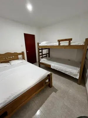 a bedroom with two bunk beds and a red door at Hospedaje Las Palmas apto 203 in Cartagena de Indias