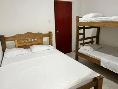a bedroom with two bunk beds and a ladder at Hospedaje Las Palmas apto 203 in Cartagena de Indias