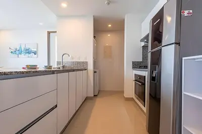 a kitchen with white cabinets and a refrigerator at Awesome Oceanfront “Morros City” 29th floor 2R/3BR in Cartagena de Indias