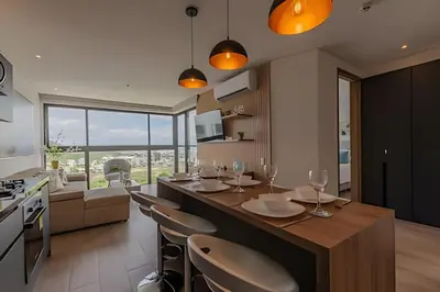 a kitchen with a large island with a table and chairs at Awesome View Historic Center, Castle and Sea 2BR in Cartagena de Indias