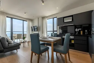 a kitchen and dining room with a table and chairs at New Apt Beautiful Sea View and Walled City 2BR in Cartagena de Indias