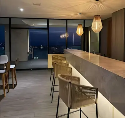 a restaurant with a bar with chairs and a view at New Apt Beautiful Sea View and Walled City 2BR in Cartagena de Indias