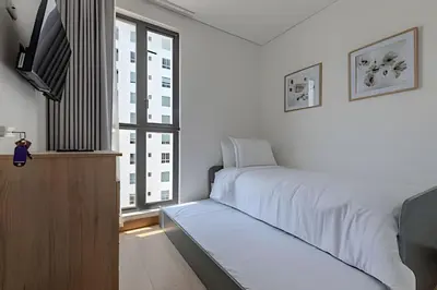 a bedroom with a bed and a tv and a window at New Apt Beautiful Sea View and Walled City 2BR in Cartagena de Indias