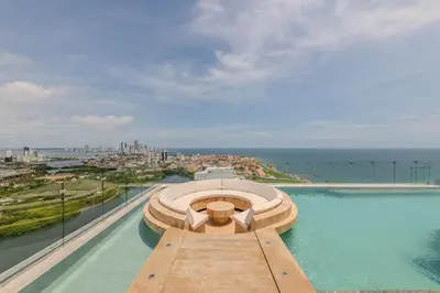 a swimming pool on top of a building with the ocean at New Apt Beautiful Sea View and Walled City 2BR in Cartagena de Indias