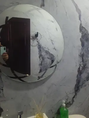a person taking a picture of a mirror in a bathroom at Casa rosymar in Cartagena de Indias