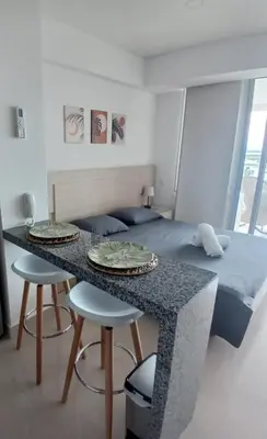 a bedroom with a bed and a table and chairs at Cartagena Beach Resort cerca al aereopuerto in Cartagena de Indias