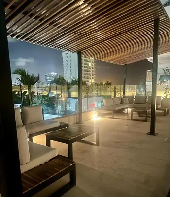 a patio with couches and a table on a building at Cartagena Beach Resort cerca al aereopuerto in Cartagena de Indias