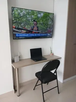 a desk with a laptop and a chair in a room at Cartagena Beach Resort cerca al aereopuerto in Cartagena de Indias