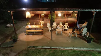 a patio with a table and chairs at night at Hotel Aqua House in Tubará
