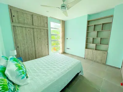 a bedroom with a white bed and a window at Magico Apartamento Frente al Mar 3 Habitaciones TR22 in Coveñas