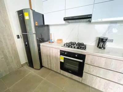 a kitchen with a stove and a refrigerator at Magico Apartamento Frente al Mar 3 Habitaciones TR22 in Coveñas