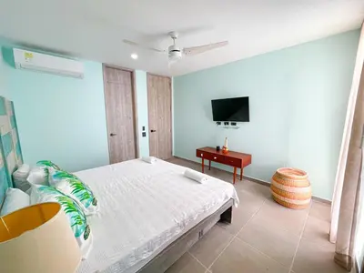 a bedroom with a bed and a flat screen tv at Magico Apartamento Frente al Mar 3 Habitaciones TR22 in Coveñas