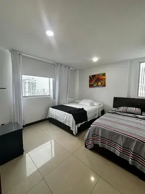 a bedroom with two beds and a window at Paraíso en Bocagrande con Vista al Mar in Cartagena de Indias