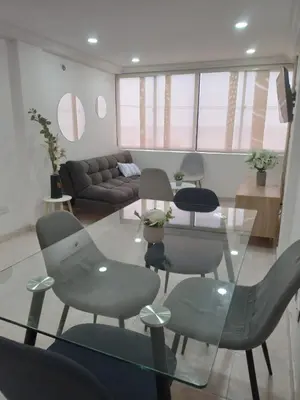 a living room with a glass table and chairs at Apto espectacular frente al mar in Cartagena de Indias