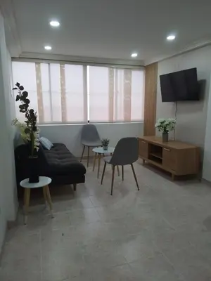 a living room with a couch and a tv at Apto espectacular frente al mar in Cartagena de Indias