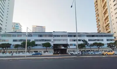 a large building with cars parked in a parking lot at Apto espectacular frente al mar in Cartagena de Indias