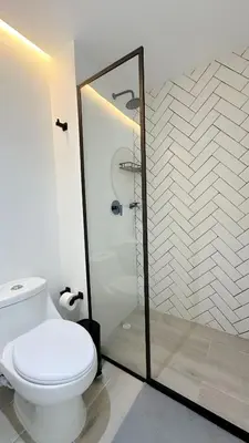a bathroom with a toilet and a glass shower at CB821 | Apartamento de lujo Vista al Mar Piscina in Cartagena de Indias