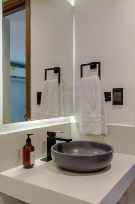 a sink in a bathroom with a mirror and towels at De la cruz Studio Apartments in Cartagena de Indias