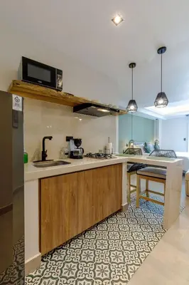 a kitchen with a sink and a microwave at De la cruz Studio Apartments in Cartagena de Indias