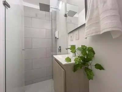 a bathroom with a sink and a shower at Bocagrande Loft - Livin Colombia in Cartagena de Indias