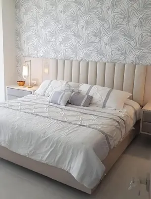 a bedroom with a large white bed with a wall at Apartamento Vista al Mar Morros Eco in Cartagena de Indias