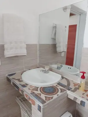 a bathroom with a sink and a bath tub at Hostal CORALES in Tolú