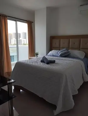 a bedroom with a bed with a hat on it at Apartamento en Cartagena, Zona Urbana in Cartagena de Indias