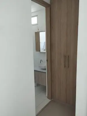 a bathroom with a sink and a wooden door at Apartamento en Cartagena, Zona Urbana in Cartagena de Indias