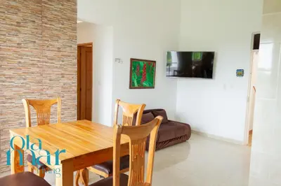 a dining room with a table and a couch at Atardeceres bloque A in Coveñas