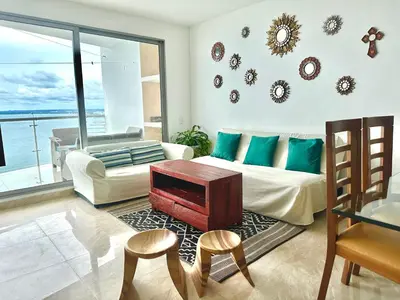 a living room with a couch and a table at by Calamari Homes - Altamar 30B1 near walled city in Cartagena de Indias