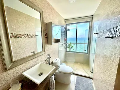 a bathroom with a sink and a toilet and a window at by Calamari Homes - Altamar 30B1 near walled city in Cartagena de Indias