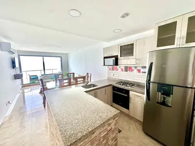 a kitchen with a stainless steel refrigerator at by Calamari Homes - Altamar 30B1 near walled city in Cartagena de Indias