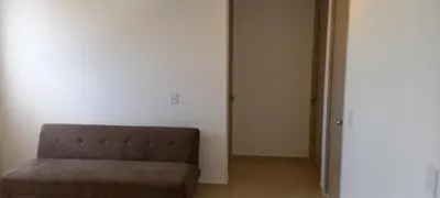 a brown chair in a room with a white wall at Apartamento - Edf Acuarium - Torices in Cartagena de Indias