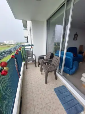 a balcony with a pool and chairs and a couch at Apartamento Cartagena - Terrazas de Calicanto in Cartagena de Indias