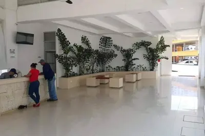 a group of people standing near a wall with plants at Apartamento Cartagena - Terrazas de Calicanto in Cartagena de Indias