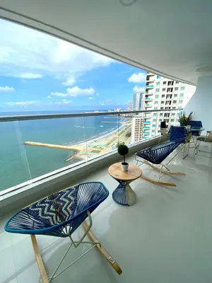 a balcony with chairs and a view of the ocean at U-GO Palmetto Eliptic - Confort y Estilo en Cartagena in Cartagena de Indias