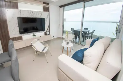 a living room with a couch and a tv and a table at U-GO Palmetto Eliptic - Confort y Estilo en Cartagena in Cartagena de Indias