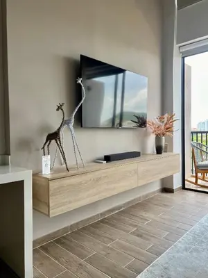a shelf with a giraffe statue in a room at Beautiful! Brand New Apt old town in Cartagena de Indias