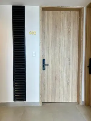 a wooden door with a sign on it in a room at Beautiful! Brand New Apt old town in Cartagena de Indias