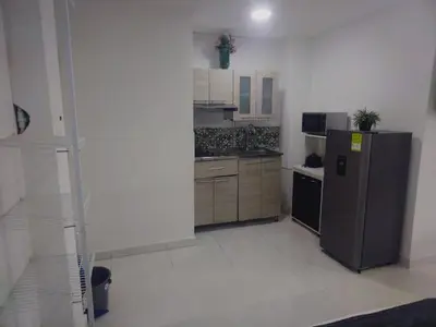 a kitchen with a stainless steel refrigerator and cabinets at Marina del rey propiedades gaitan in Cartagena de Indias