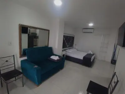 a room with a couch and a bed and a mirror at Marina del rey propiedades gaitan in Cartagena de Indias