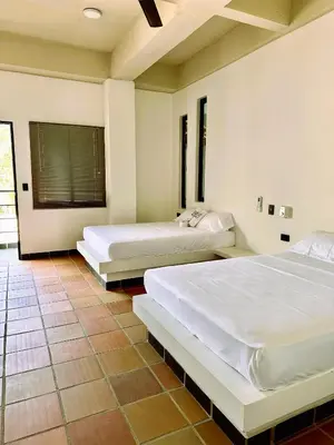 a bedroom with two beds and a window at Santa Donama Paradise in Santa Marta