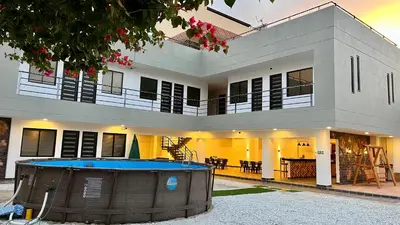 a house with a swimming pool in front of it at Santa Donama Paradise in Santa Marta
